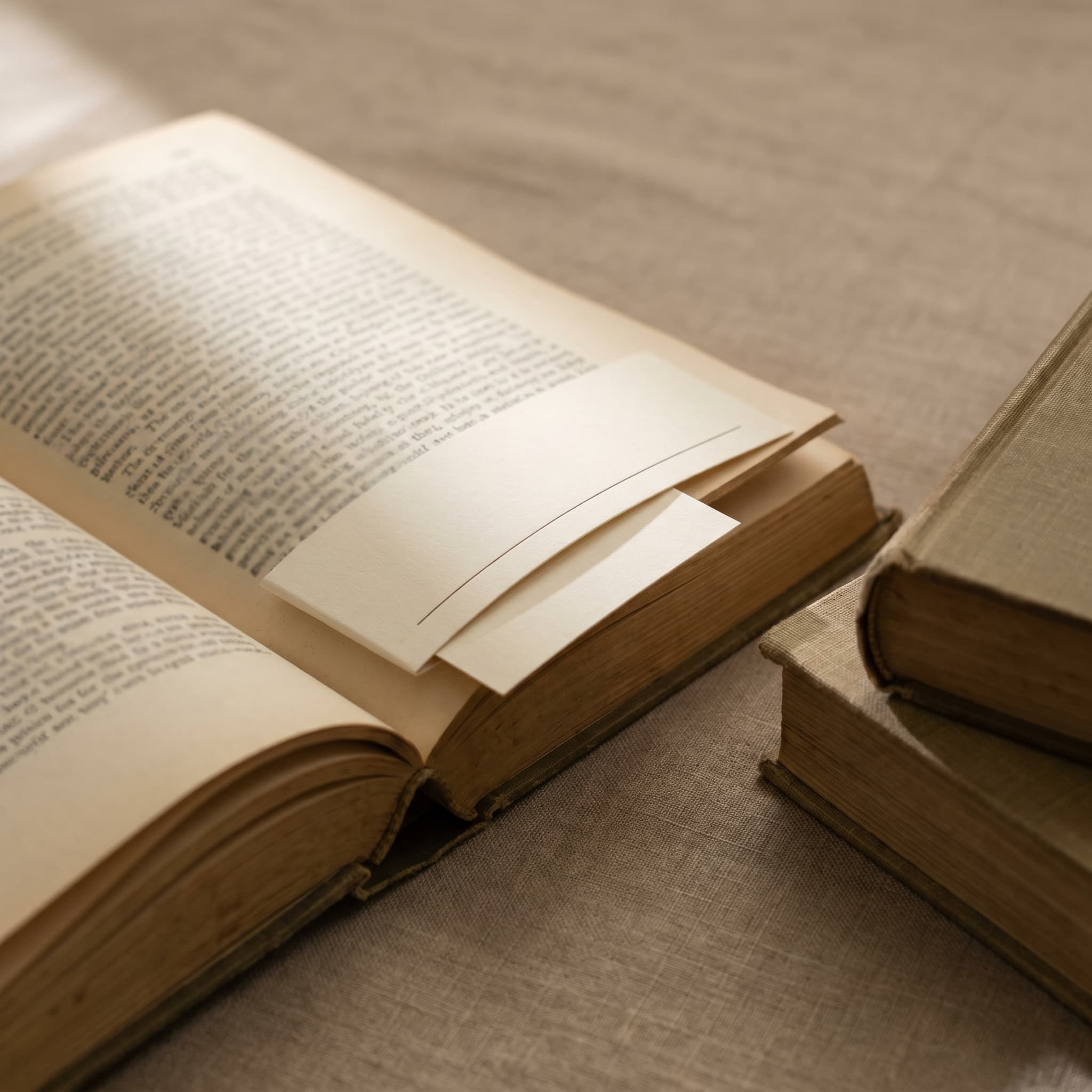 Cream ritual card used as bookmark inside an open book