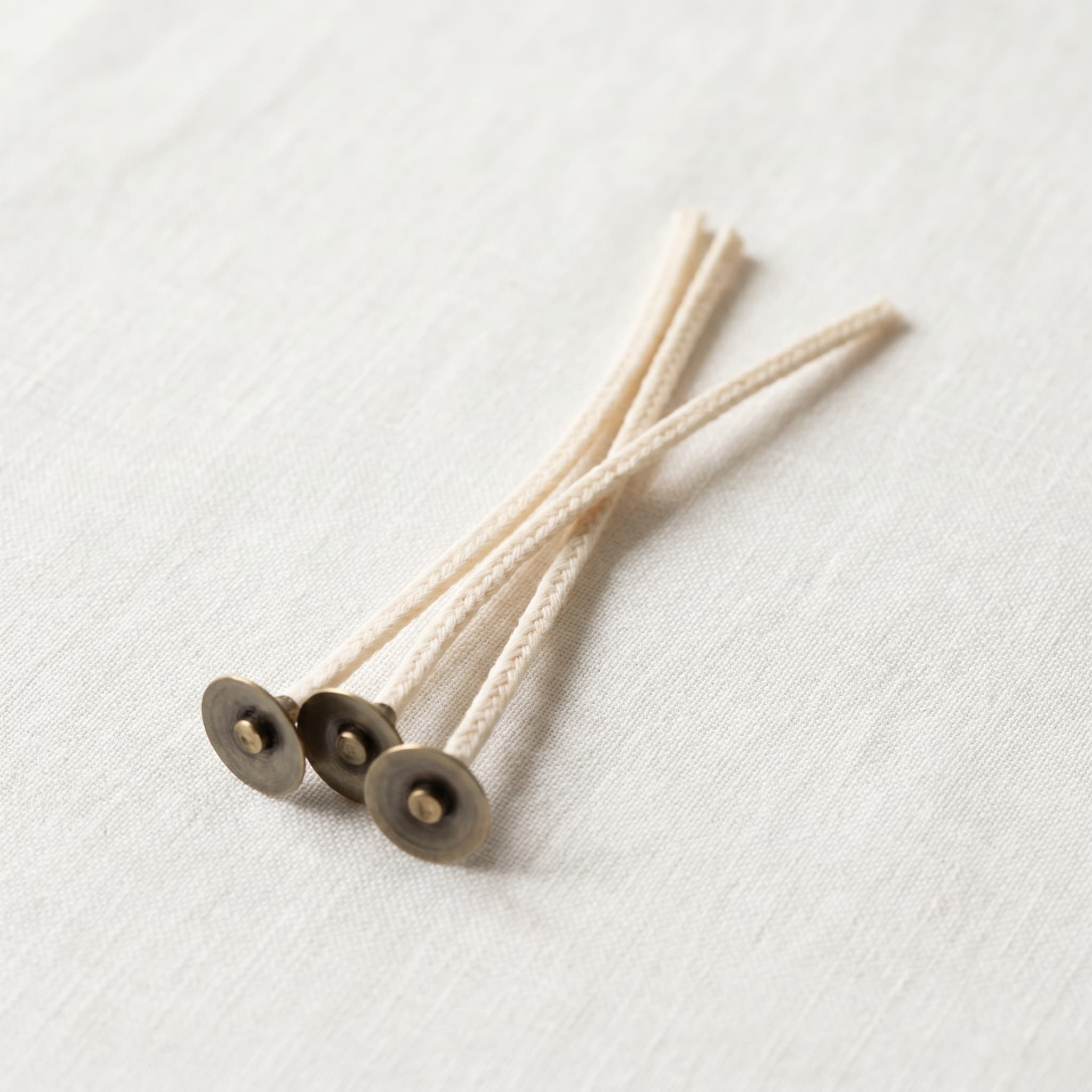 A braided cotton wick against a white background