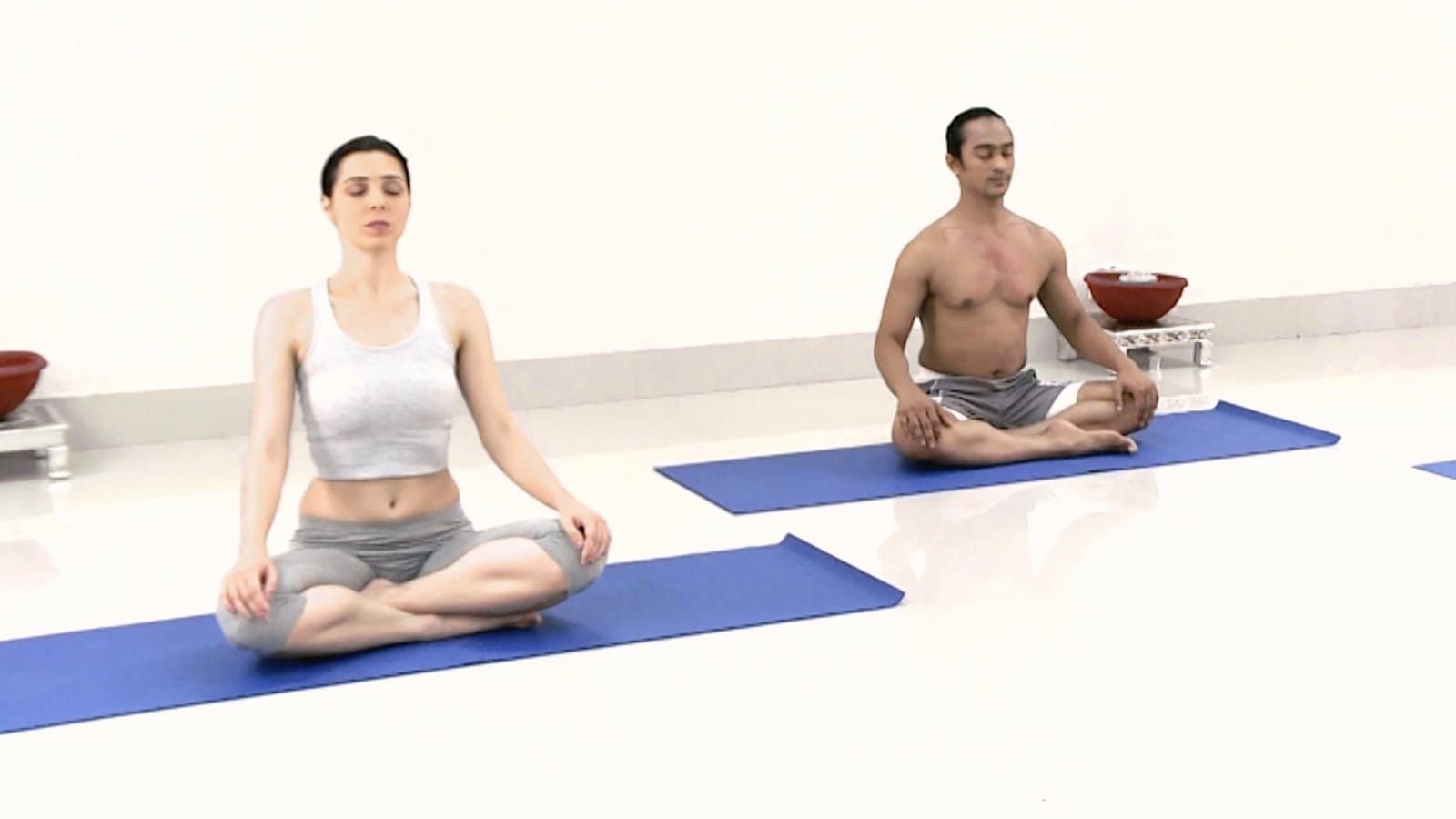 A night practice — two practitioners seated in quiet meditation.