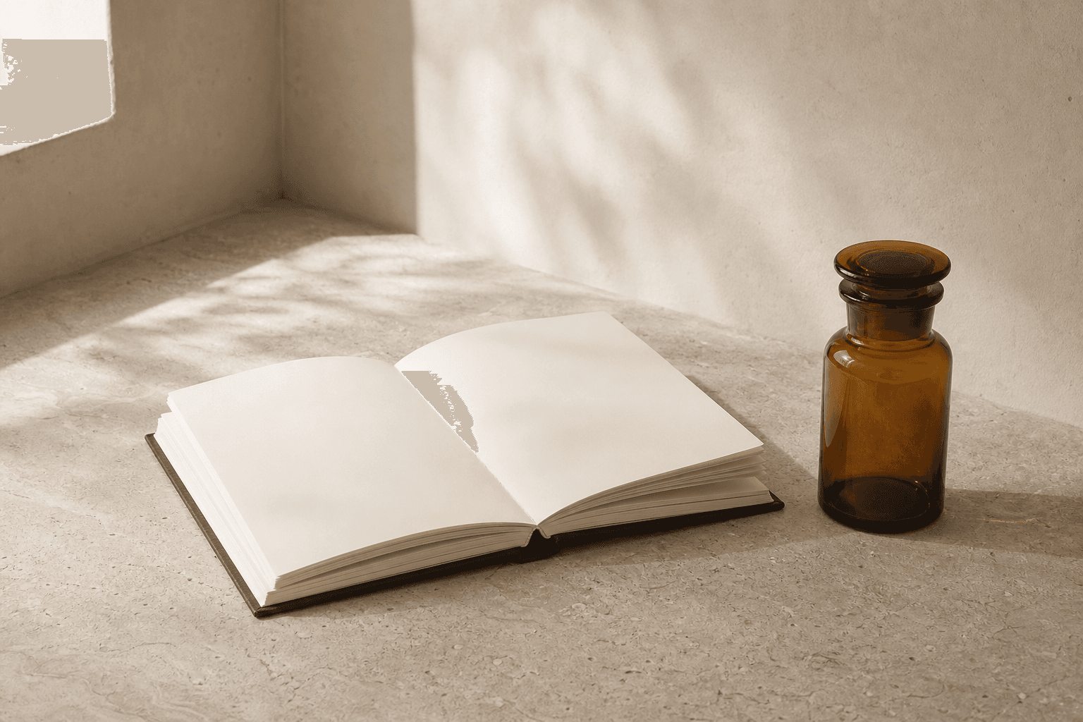 An open notebook on a wooden table with a small amber jar beside it, soft window light.